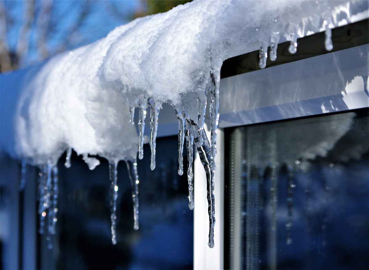 icicles hanging off the roof of a home; 10 Tips for Home Snow and Ice Removal